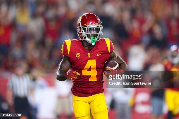 Trojans wide receiver Mario Williams runs to the bench after scoring a touchdown during a college football game between the Washington State Cougars...