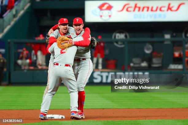 Jean Segura, Rhys Hoskins and Bryson Stott of the Philadelphia Phillies celebrate their Wild Card Series game two win over the St. Louis Cardinals at...