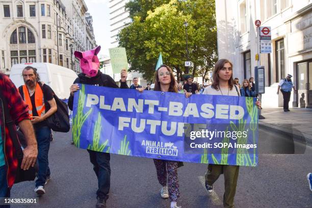 Animal Rebellion activists march with a "Plant based future" banner during the protest. The animal rights group marched in Central London demanding...