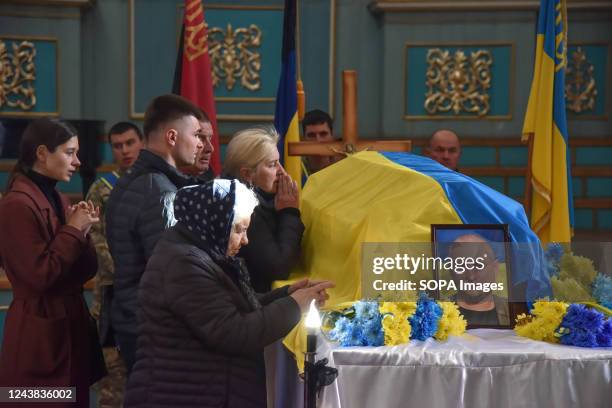 Relatives mourn near the coffin of lieutenant colonel Valery Matviychuk during his funeral ceremony at the organ hall of the city of Sambir....