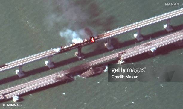 Maxar closeup satellite imagery of burning rail cars and the damage to the Kerch Bridge in Crimea. Please use: Satellite image 2022 Maxar...