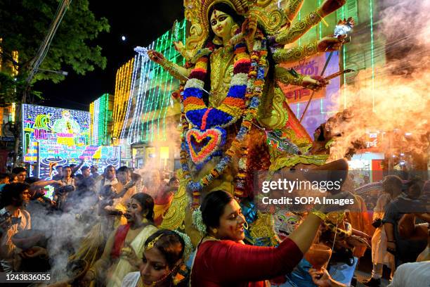 Hindu devotees with traditional Bengali dresses perform rituals during the immersion procession of Durga Puja at Bagbazar. Vijaya Dashami is the last...