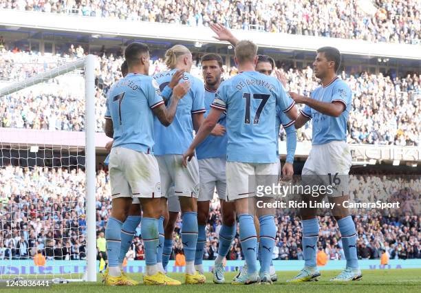 Manchester City's Erling Haland celebrates with team-mates after scoring his side's fourth goal during the Premier League match between Manchester...