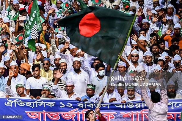 Muslim devotees carry a Bangladesh national flag as they take part in a rally to mark Eid-e-Milad-un-Nabi, the birthday of the Prophet Mohammad, in...