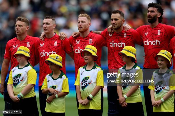 England's players line up for the national anthems during the first cricket match of the Twenty20 series between Australia and England in Perth on...