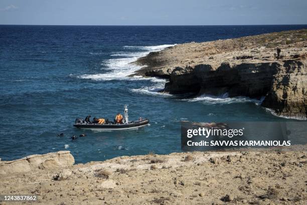 Greek coastguard rescuers recover a body from the sea off Kythira Island at the south of the Peloponnese peninsula on October 8, 2022. - The death...
