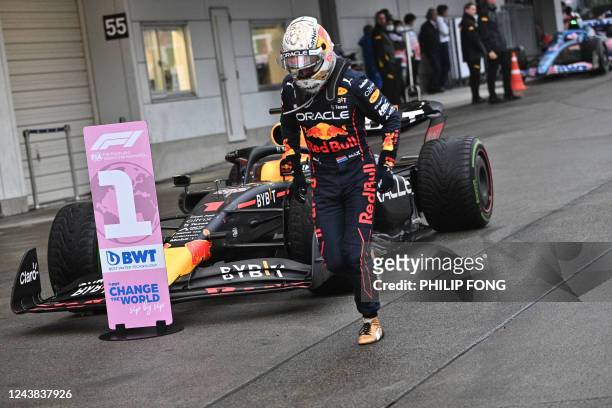 Red Bull Racing's Dutch driver Max Verstappen gets out of his car after his victory in the Formula One Japanese Grand Prix at Suzuka, Mie prefecture...