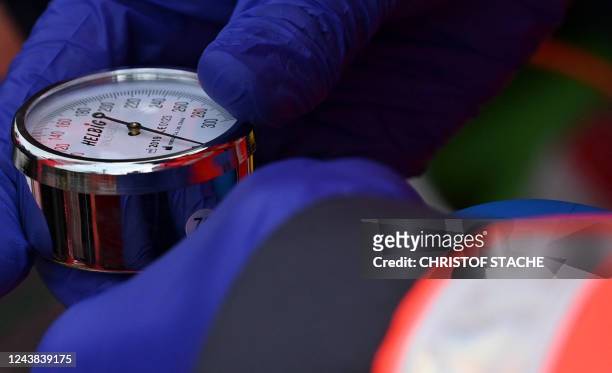 An emergency doctor measures the blood pressure during a rescue drill of the emergency services in Munich, southern Germany, on October 8, 2022. A...