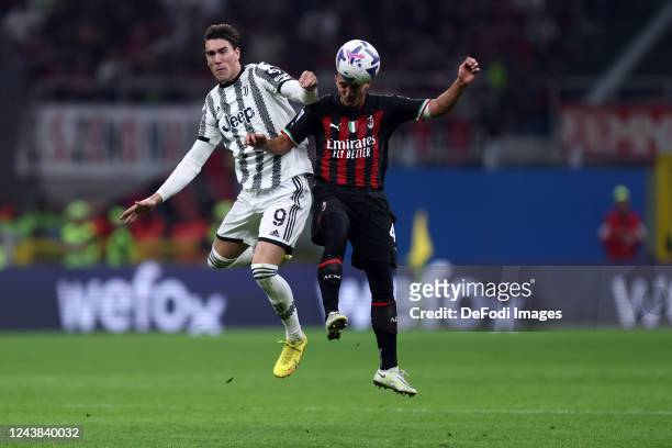 Dusan Vlahovic of Juventus FC and Ismael Bennacer of AC Milan battle for the ball during the Serie A match between AC MIlan and Juventus at Stadio...