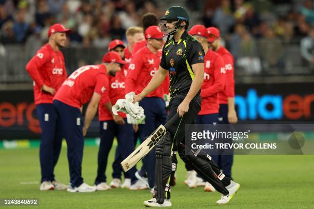 Australia's Tim David walks off after his dismissal Australia's Marcus Stoinis during the first cricket match of the Twenty20 series between...