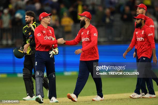 England's Jos Buttler shakes hands with Moeen Ali after their victory in the first cricket match of the Twenty20 series between Australia and England...