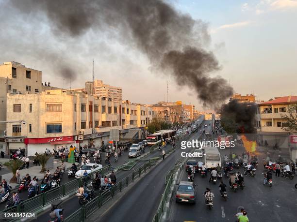 Picture obtained by AFP outside Iran, reportedly shows a motorcycle on fire in the capital Tehran, on October 8, 2022. - Iran has been torn by the...