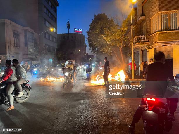 Picture obtained by AFP outside Iran, reportedly shows objects lit on fire in the capital Tehran, on October 8, 2022. - Iran has been torn by the...