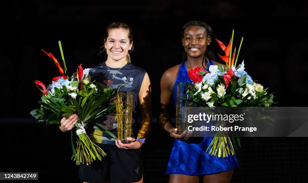 Catherine McNally of the United States and Alycia Parks of the United States pose with their champions trophies after defeating Alicja Rosolska of...