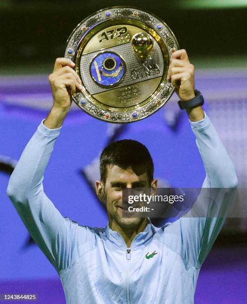 Serbia's Novak Djokovic celebrates with the trophy after defeating Greece's Stefanos Tsitsipas in their men's singles final match at the Astana Open...