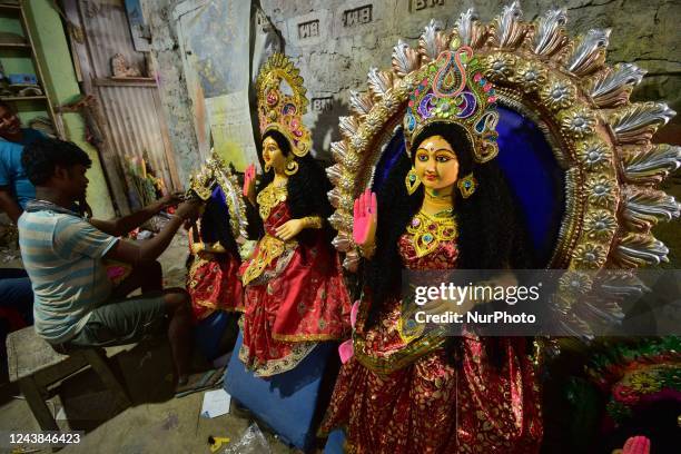 An artisan decorates an idol of Goddess Laxmi at a workshop during Lakshmi Puja celebrations, in Nagaon district of Assam,India on Oct 9,2022.