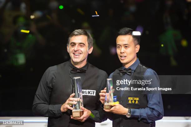 Ronnie O'Sullivan of England and Marco Fu of Hong Kong poses with the trophy after Ronnie O'Sullivan of England wins the Hong Kong Masters 2022 Final...