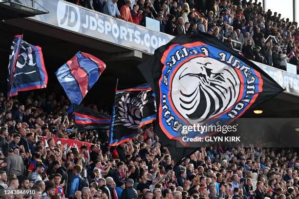 Palace fans wave flags during the English Premier League football match between Crystal Palace and Leeds United at Selhurst Park in south London on...