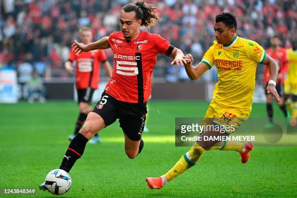 Rennes' Belgian defender Arthur Theate fights for the ball with Nantes' Egyptian forward Mostafa Mohamed during the French L1 football match between...
