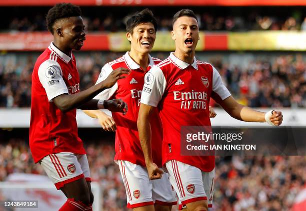 Arsenal's Brazilian midfielder Gabriel Martinelli celebrates scoring his team's first goal with teammates during the English Premier League football...