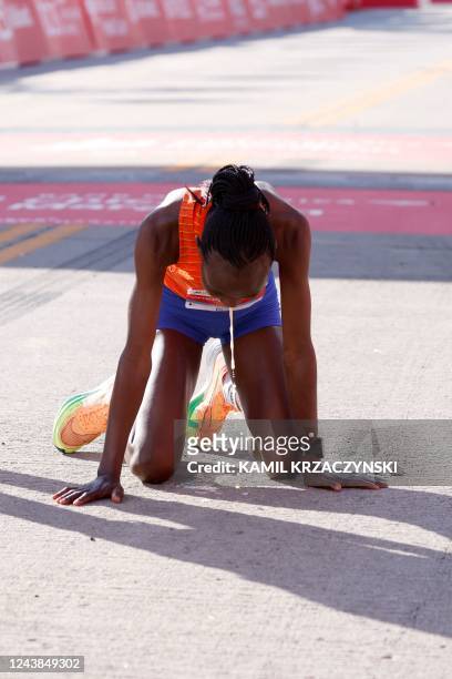 Kenya's Ruth Chepngetich reacts after crossing the finish line to place first in the women's division of the 2022 Bank of America Chicago Marathon in...
