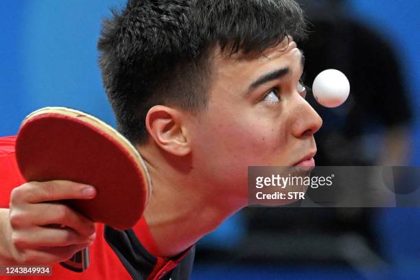 Germany's Kay Stumper serves against Chinas Wang Chuqin during the World Team Championships Finals table tennis men's final match in Chengdu in...