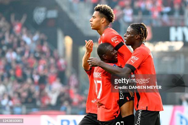 Rennes' French midfielder Desire Doue celebrates with teammates after scoring his team's third goal during the French L1 football match between Stade...