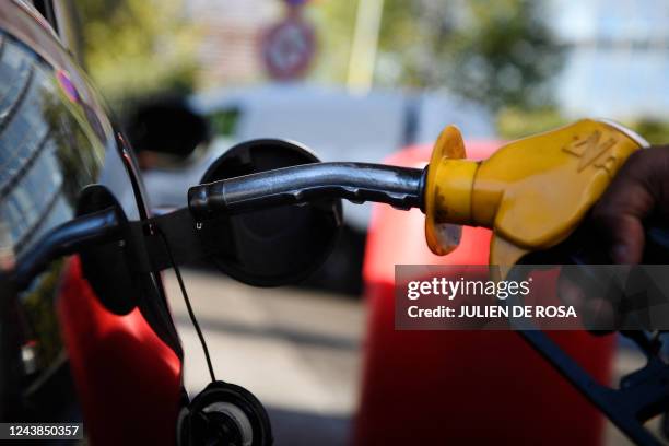 Drop of gasoline falls from a nozzle at a TotalEnergies fuel station in Paris, on October 9, 2022. - Across France, nearly one in five filling...