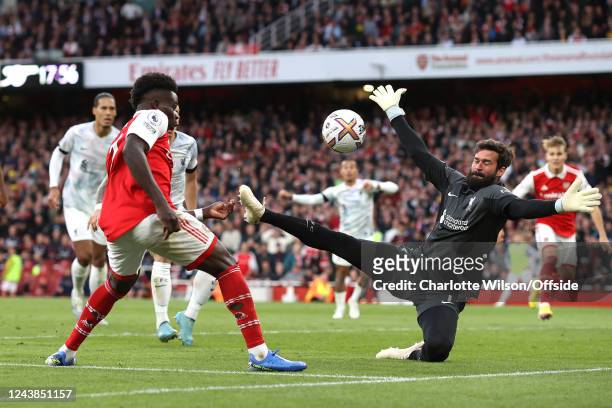 Liverpool goalkeeper Alisson Becker saves at close range from Bukayo Saka of Arsenal during the Premier League match between Arsenal FC and Liverpool...