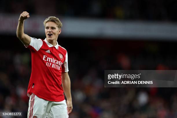 Arsenal's Norwegian midfielder Martin Odegaard celebrates winning the English Premier League football match between Arsenal and Liverpool at the...