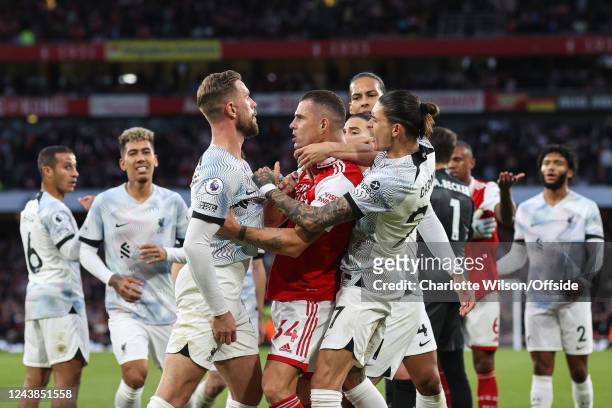 Granit Xhaka of Arsenal is pulled away from Jordan Henderson of Liverpool by Darwin Nunez during the Premier League match between Arsenal FC and...