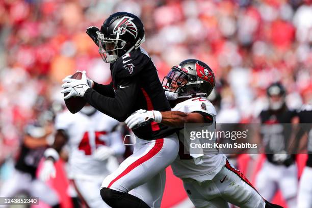 Antoine Winfield Jr. #31 of the Tampa Bay Buccaneers tackles Drake London of the Atlanta Falcons after a catch during the first quarter of the game...