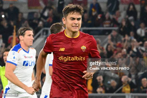 Roma's Argentinian forward Paulo Dybala reacts, due to an injury, after scoring a penalty kicks during the Italian Serie A football match between AS...