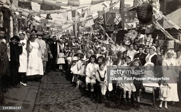 Peace celebrations including a street party, children and Red Cross nurses, following the end of World War One in Newcastle, circa 1919.