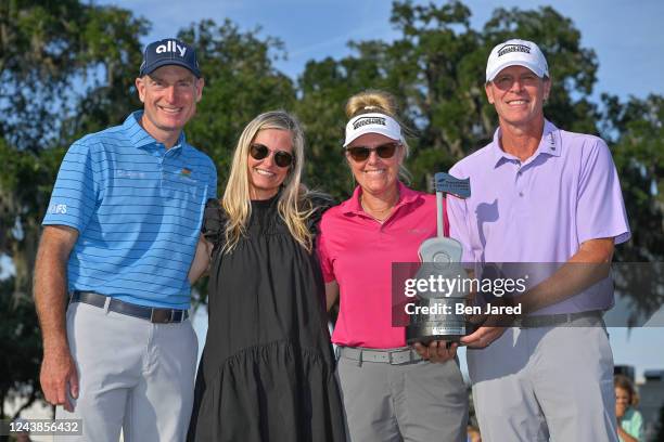 Jim Furyk, Tabitha Furyk, Nicki Stricker and Steve Stricker stand together with the trophy on the 18th green after the final round of the PGA TOUR...