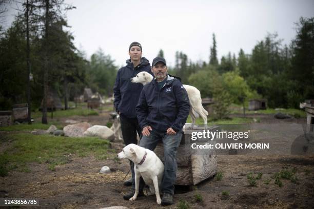 Canadian musher David Daley, pose with his son Wyatt Daley in CHurchill, northern Canada, on August 10, 2022. - Churchill is a small isolated town on...