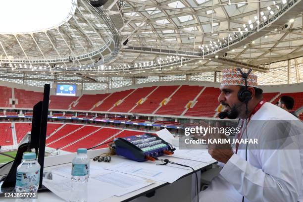 Omani Khalil al-Balushi, a commentator for the Qatari Alkass Sports Channels, is pictured during the Qatar Stars League football match between...