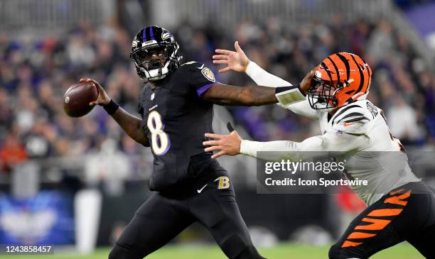 Baltimore Ravens quarterback Lamar Jackson throws while under pressure from Bengals defensive end Trey Hendrickson during the Cincinnati Bengals...