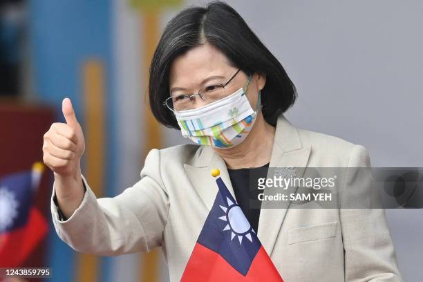 Taiwan's President Tsai Ing-wen gives a thumbs-up sign as she attends a ceremony to mark the island's National Day in front of the Presidential...