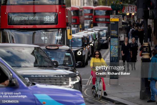 Pedestrians cross the road infront of heavy traffic at the top of Whitehall in the capital, on 6th October 2022, in London, England.