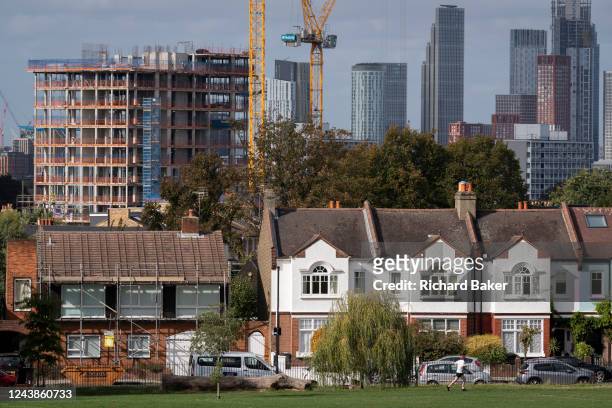 Residential London homes in the foreground and new high-rises under construction in the capital - and in the distance, the growing development at...
