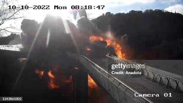 Screen grab taken from a surveillance camera shows an explosion rocked a bridge in the Shevchenkivskyi district of the Ukrainian capital, Kyiv on...