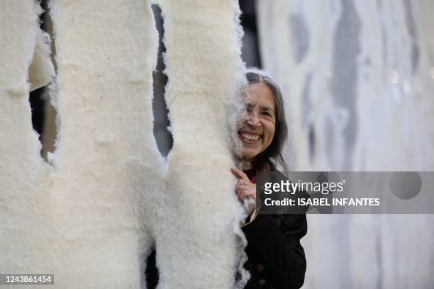 Chilean artist Cecilia Vicuna poses by her artwork of the latest Hyundai Commission for Tate Modern's Turbine Hall, in London, on October 10, 2022. -...