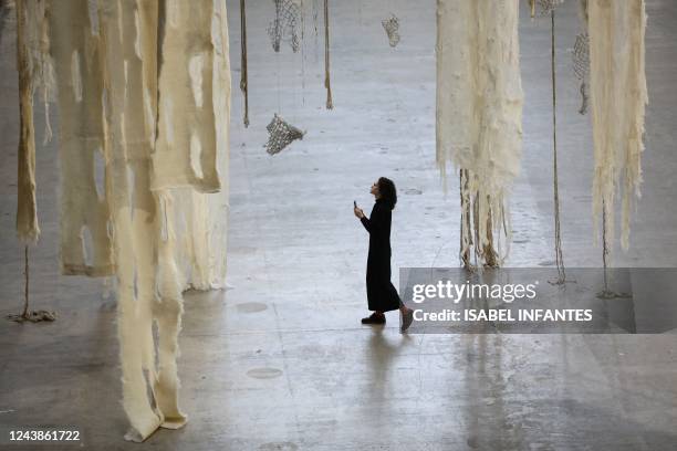 Gallery assistant looks at the latest Hyundai Commission for Tate Modern's Turbine Hall, by Chilean artist Cecilia Vicuna displayed at the museum, in...