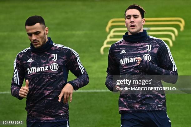 Juventus' Serbian midfielder Filip Kostic and Juventus Serbian forward Dusan Vlahovic take part in a training session on the eve of the UEFA...