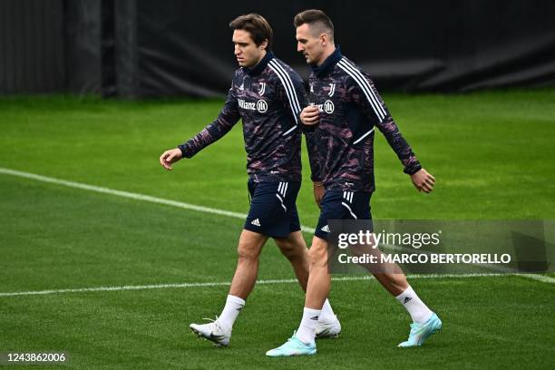 Juventus' Italian forward Federico Chiesa and Juventus Polish forward Arkadiusz Milik take part in a training session on the eve of the UEFA...