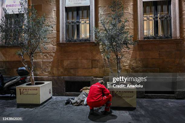 Volunteer of Croce Rossa Italiana gives assistance to a homeless man central in Milan, Italy on October 7, 2022. October 10th marks World Homeless...