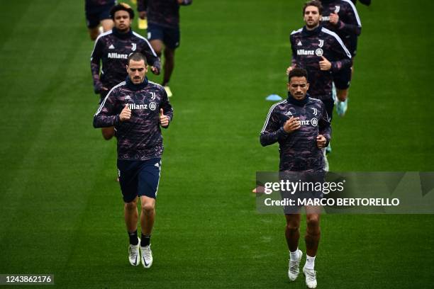 Juventus' defender Leonardo Bonucci from Italy and Juventus' defender Danilo from Brazil take part in a training session on the eve of the UEFA...