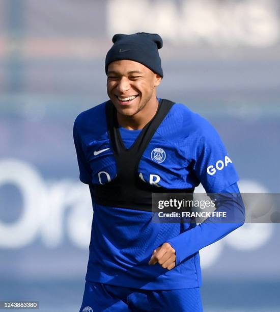 Paris Saint-Germain's French forward Kylian Mbappe reacts during a training session at the club's Camp des Loges training ground in...