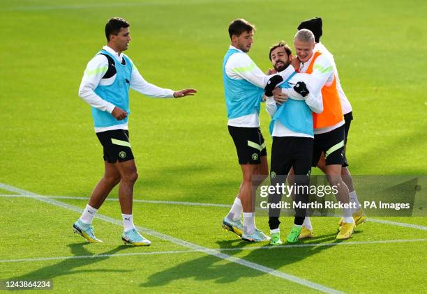 Manchester City's Bernardo Silva, Erling Haaland and Ruben Dias during a training session at the City Football Academy, Manchester. Picture date:...